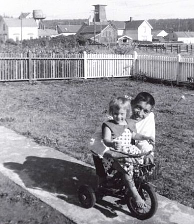 Lucia Zacha, with her father, in the front yard of the Albert Brown House (1959).
